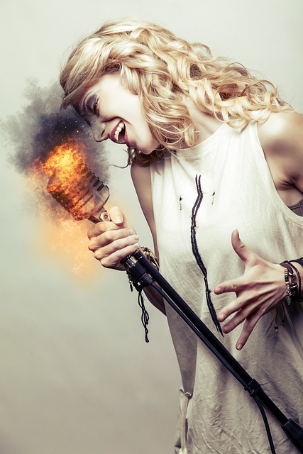 Woman singing into a microphone with fire